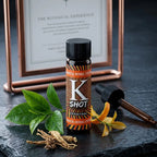 K Shot bottle with botanical elements on a dark surface